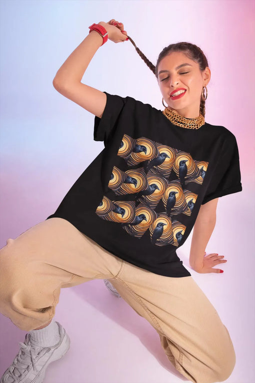 Model wearing a black graphic t-shirt with a vibrant wave design, posing playfully.