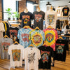 A collection of graphic t-shirts representing the evolution of design from vintage to modern styles