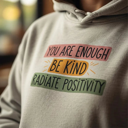 Close-up of a graphic hoodie featuring a positive affirmation and hand-drawn details