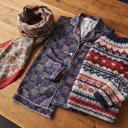 Close-up of unique artistic affirmation pieces: a vintage tee, unisex hoodie, and children’s top with positive messages