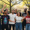 Diverse group of people wearing colorful custom graphic tees in an outdoor setting, showcasing artistic expression and individuality