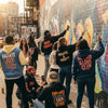 Diverse group wearing affirmation streetwear in an urban setting, promoting positivity and self-empowerment