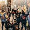 Diverse group wearing affirmation streetwear in an urban setting, promoting positivity and self-empowerment