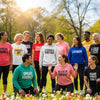 Diverse group wearing inspirational apparel in a sunny park, promoting positivity and self-expression