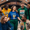 Diverse group wearing Liverpool music-inspired clothing against iconic landmarks, showcasing unique designs and cultural heritage