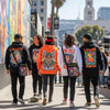 Diverse group wearing unique graphic apparel in Los Angeles, showcasing self-expression through clothing