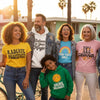 Diverse group wearing vintage affirmation clothing outdoors, showcasing positivity and self-expression