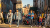 Diverse individuals in nostalgic streetwear against an urban backdrop, showcasing retro fashion trends