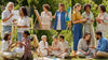 Diverse individuals in sustainable clothing enjoying creative activities outdoors, embodying the spirit of conscious fashion