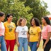 Diverse women wearing positive affirmation tees in a sunny outdoor setting, promoting empowerment and self-love
