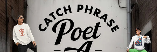 Two people dressed in casual clothing standing beside a large wall sign that reads "CATCH PHRASE Poet A.