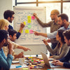 Group of diverse individuals brainstorming catchy phrases in a creative workspace