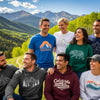 Group of people in mountain-inspired apparel against a Colorado mountain backdrop