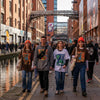 Manchester street scene with people in industrial chic streetwear, highlighting unique graphic tees and hoodies