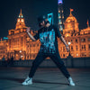 Model in futuristic Shanghai skyline graphic tee against The Bund's neon-lit architecture