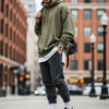 Model showcasing oversized silhouettes in urban fashion, highlighting comfort and style