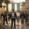 Models showcasing the Merlion Muse Mix streetwear collection against a backdrop of Singaporean architecture, highlighting cultural motifs and contemporary design.