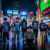 Tokyo street scene with people in neon-inspired streetwear, highlighting urban fashion and vibrant city life