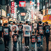 Vibrant Osaka street scene with people wearing custom graphic tees inspired by Japanese art and culture