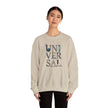 Woman wearing beige sweatshirt with 'UNIVERSAL' letters featuring landmark designs