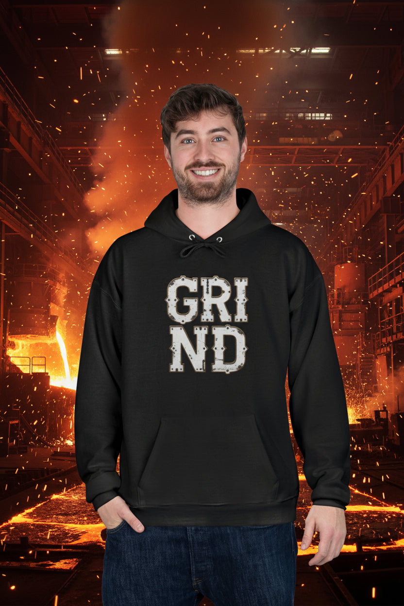 Man wearing a black hoodie with 'GRIND' text on a white background