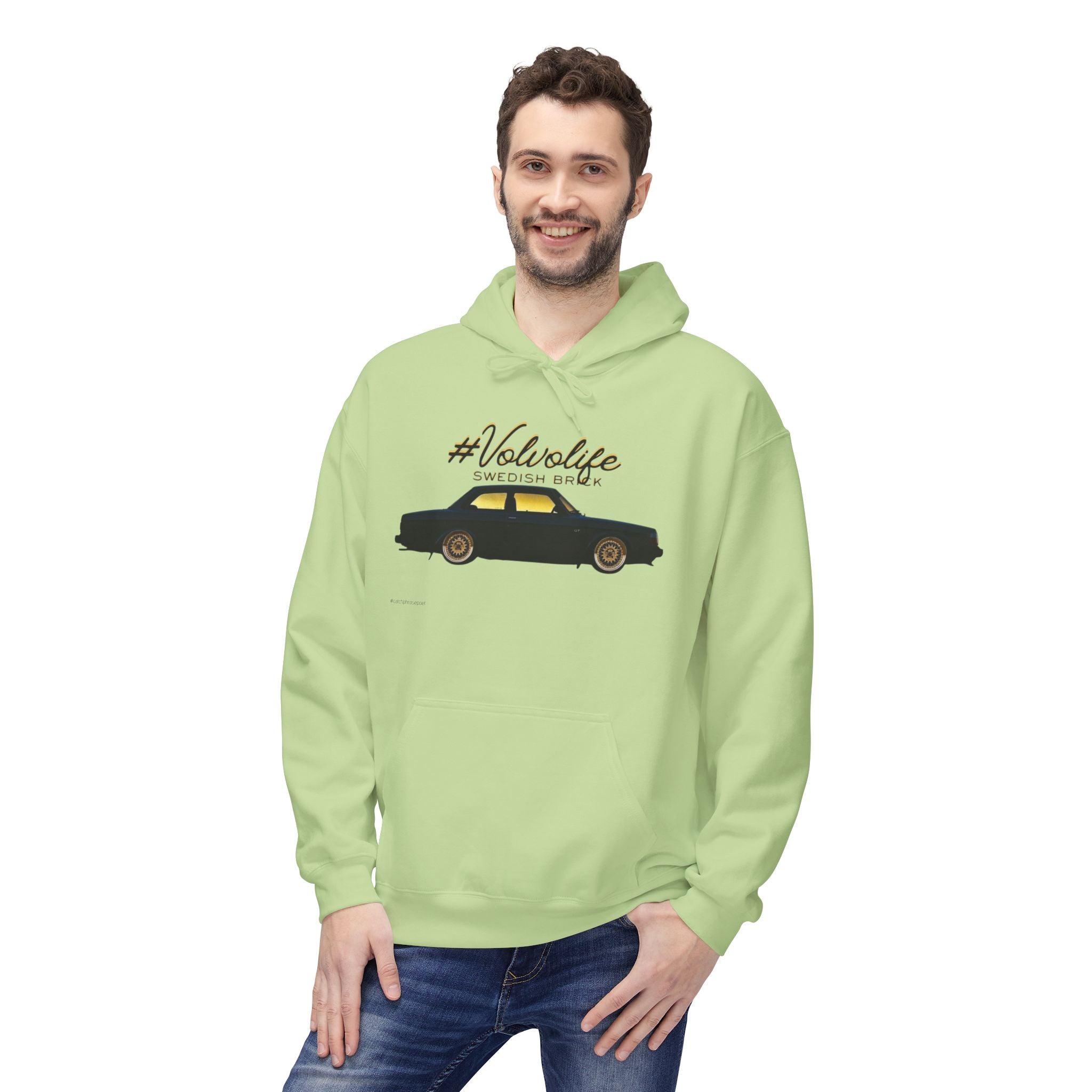 Smiling man in light green hoodie with Volvo car graphic and #Volvolife Swedish Brick text