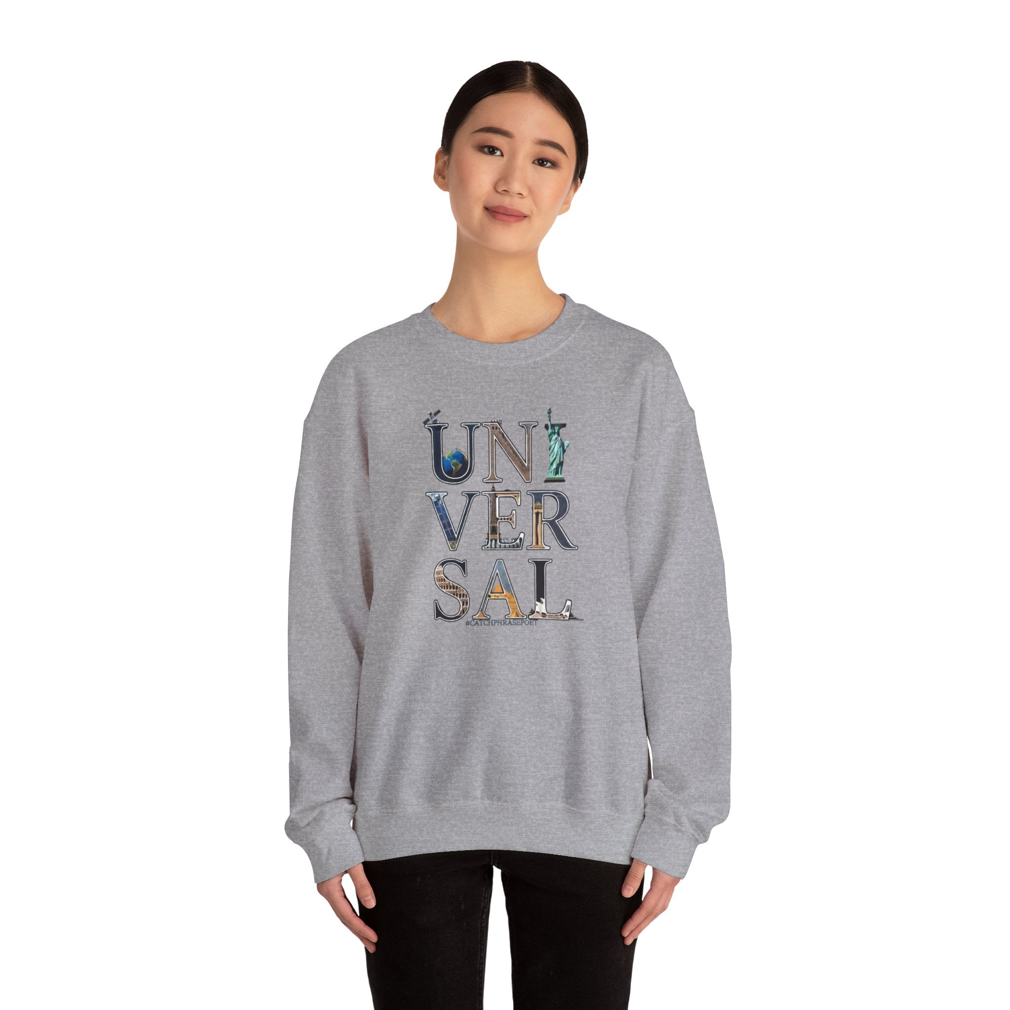 Woman wearing gray sweatshirt with 'UNIVERSAL' graphic and landmark illustrations