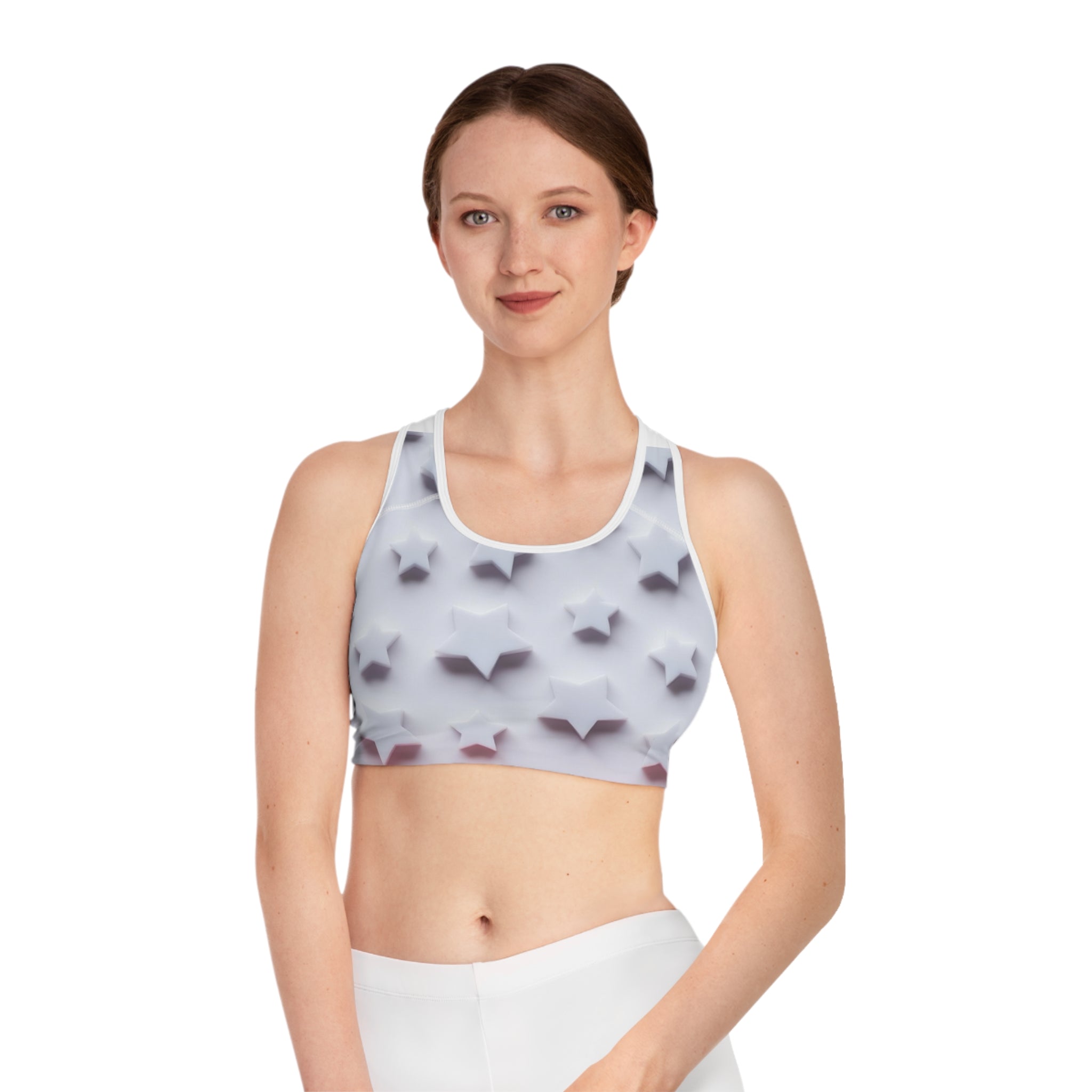 Woman wearing a white sports bra with 3D star pattern, athletic apparel, studio background