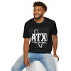 Man wearing black ATX Texas graphic T-shirt, casual outfit, seated on white block