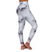 Woman wearing high-waisted leggings with geometric abstract pattern, side view