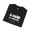 Black folded t-shirt with bold white and orange text graphic and motivational phrase.