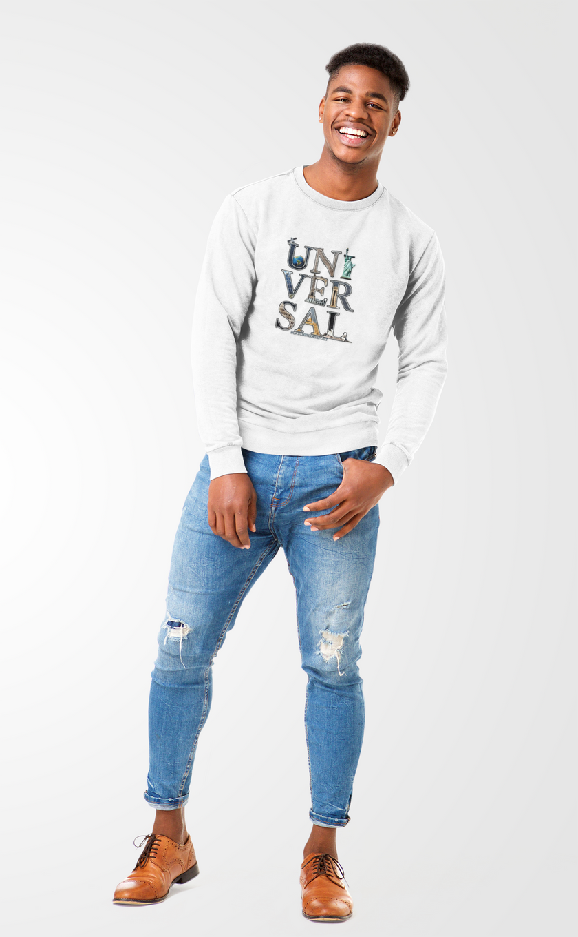 Smiling man in white UNIVERSAL graphic sweatshirt, ripped jeans, and brown shoes