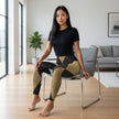 Woman in modern living room wearing black t-shirt and geometric print leggings