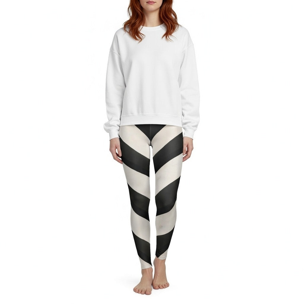 Woman wearing black and white striped leggings and a plain white sweatshirt