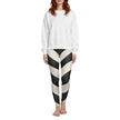 Woman wearing black and white striped leggings and a plain white sweatshirt