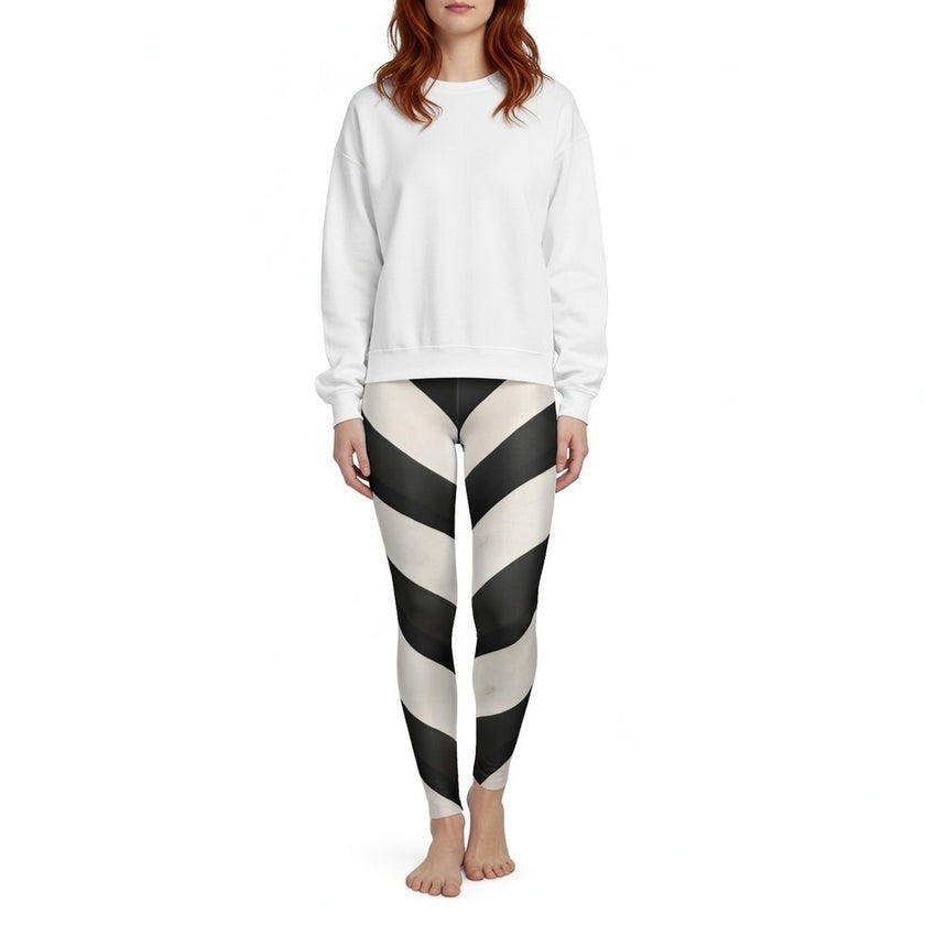 Woman wearing black and white striped leggings and a plain white sweatshirt