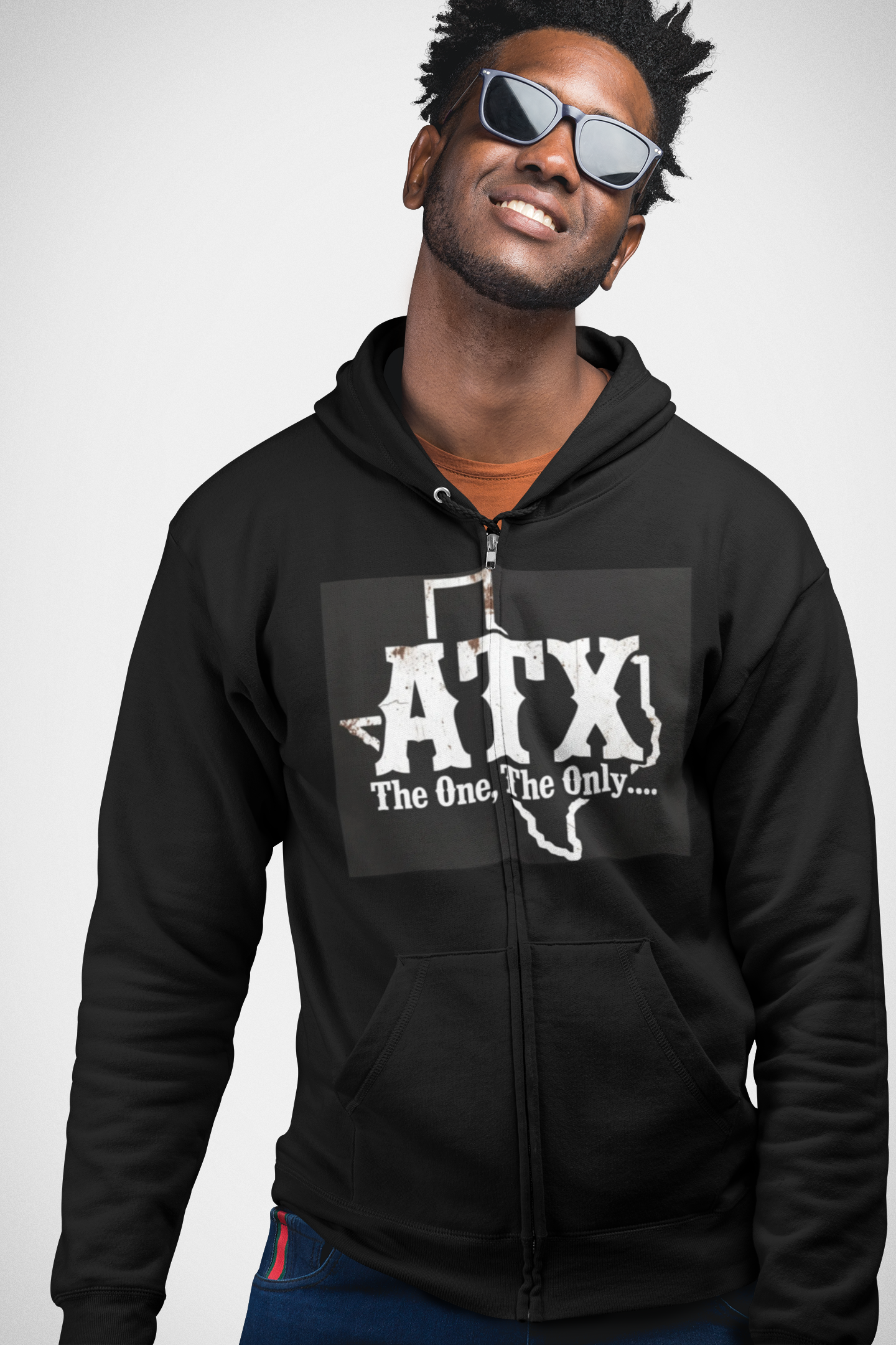 Man wearing black zip hoodie with ATX The One, The Only Texas graphic, casual fashion