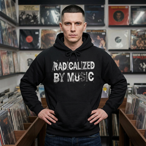 Man wearing a black hoodie with 'RADICALIZED BY MUSIC' text in a record store.