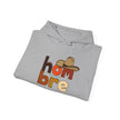 Folded grey hoodie with 'hombre' text and cowboy hat graphic on front