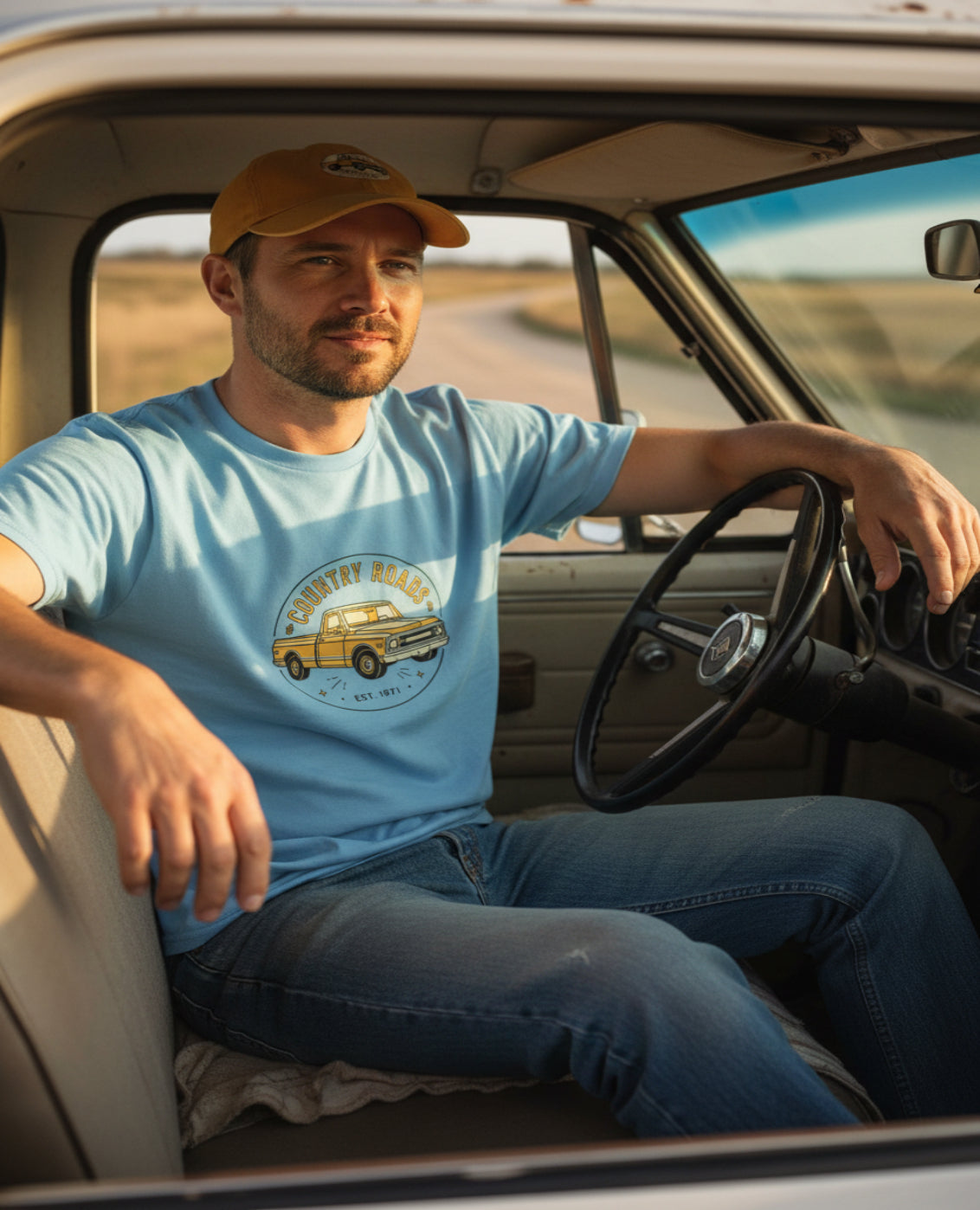 Light blue t-shirt with a yellow truck graphic and 'Country Roads' text on a white background