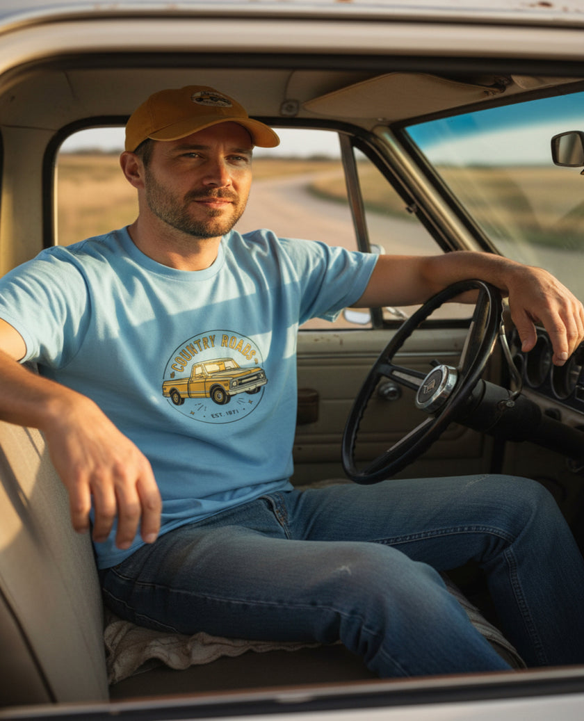 Light blue t-shirt with a yellow truck graphic and 'Country Roads' text on a white background