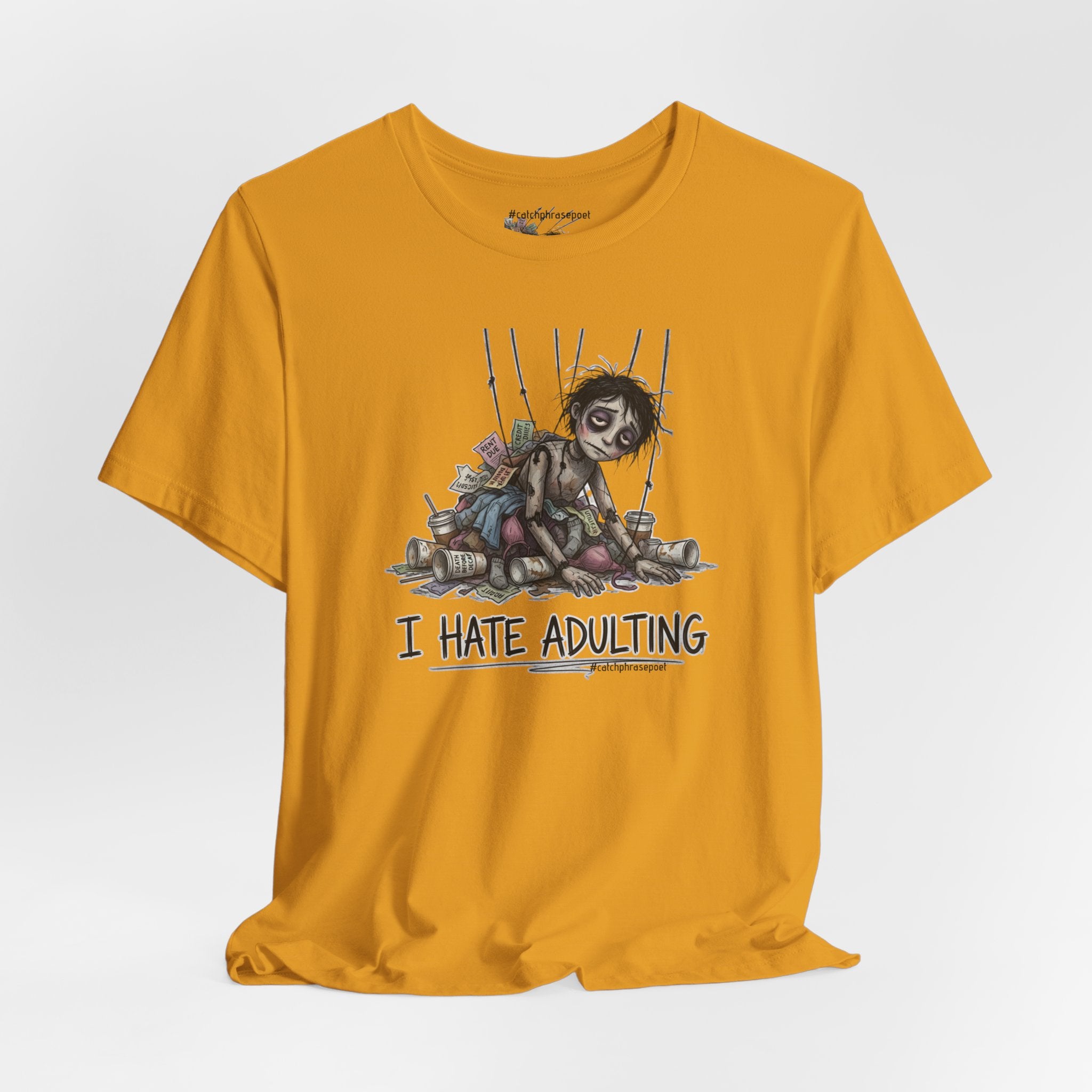 Yellow t-shirt with graphic design and text 'I Hate Adulting' on a white background