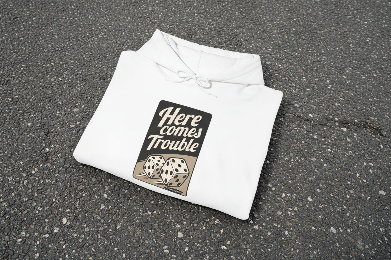 White hoodie with 'Here comes Trouble' text and dice design on a white background