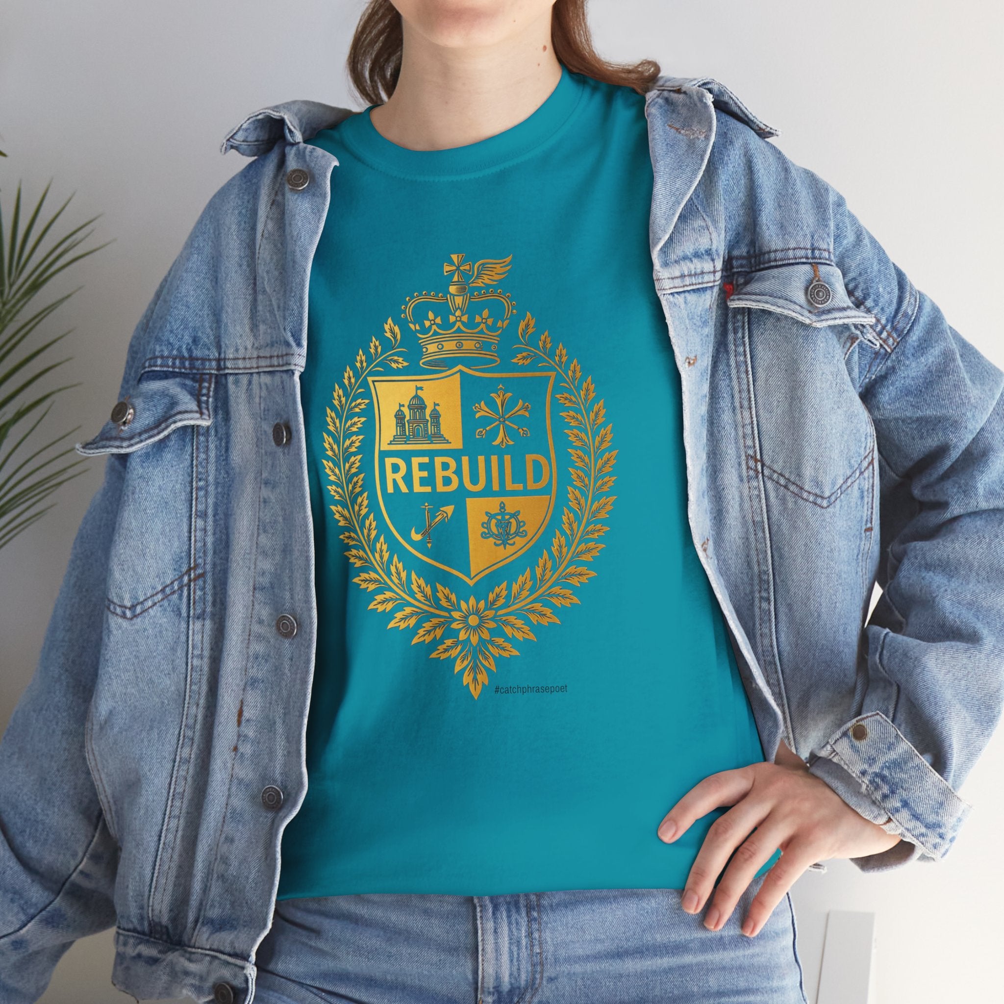 Woman wearing teal t-shirt with gold 'REBUILD' crest, paired with denim jacket.
