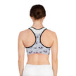 Woman wearing racerback sports bra with 3D star pattern on white background