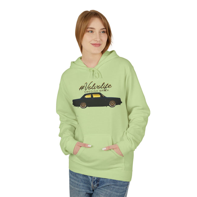 Woman in light green hoodie with #Volvolife Swedish Brick car graphic, casual fashion style