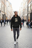 Man wearing a black hoodie with a white graphic design on a white background