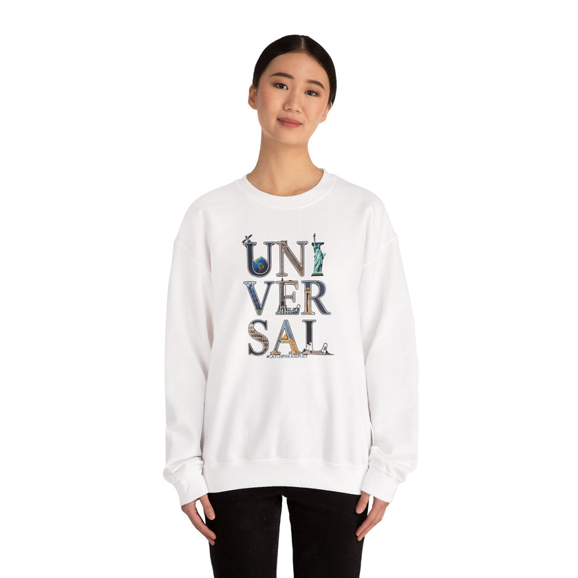 Woman wearing a white sweatshirt with 'UNIVERSAL' and landmarks graphic on front
