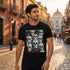 Woman walking a malamute on a Baja beach at sunset wearing the white Day of the Dead black-and-white sugar skull tee — Catch Phrase Poet